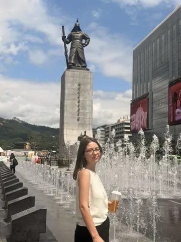 Viajante na praça Gwanghwamun com a estátua do almirante Yi Sun-sin e as fontes